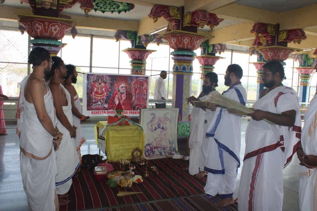 Ritwiks reciting the Vedas in the temple mandapam, the Paramacharya's portrait behind them